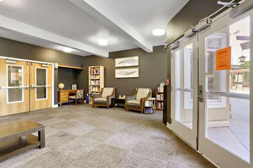A room with a carpeted floor and a glass door.