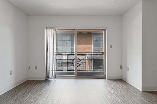A room with a sliding glass door leading to a balcony at Pin Yuen, Sacramento, CA