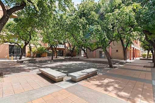 A courtyard with a fountain surrounded by trees and buildings at Pin Yuen