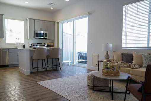 A modern kitchen with a dining area and a living room at Zora Encanto, Phoenix, AZ 85035
