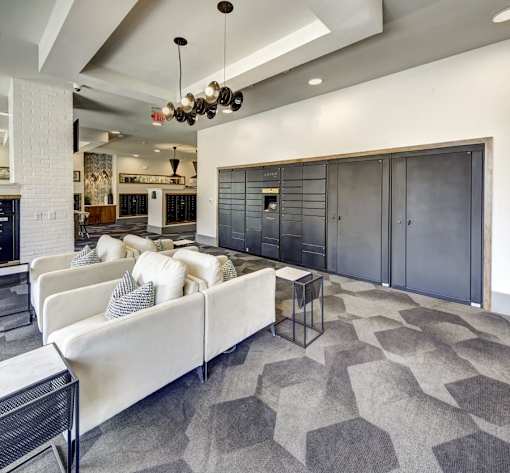 A modern living room with a white couch and a black and white rug at Arise Riverside Apartments, Austin, 78741