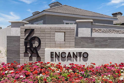 a building with a sign and flowers in front of it at Zora Encanto, Phoenix, 85035