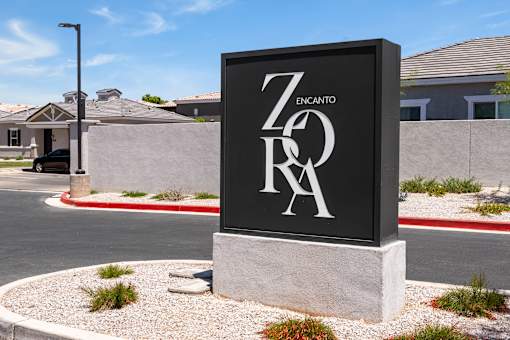 a sign in front of a road with a house in the background at Zora Encanto, Phoenix, Arizona