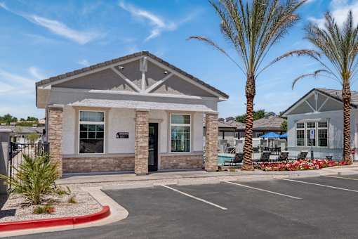 the front of a building with palm trees and a parking lot at Zora Encanto, Arizona