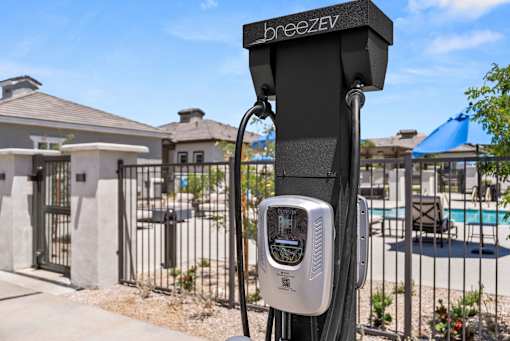a parking meter in front of a fence and a pool at Zora Encanto, Phoenix, 85035