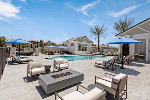 a swimming pool with chairs and tables and umbrellas at Zora Encanto, Arizona 85035