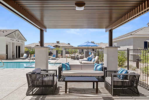 a resort style pool with lounge chairs and umbrellas at Zora Encanto, Arizona 85035