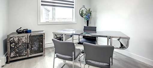 A white room with a table and chairs.