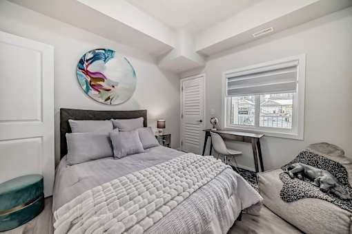 a bedroom with a large bed and a window