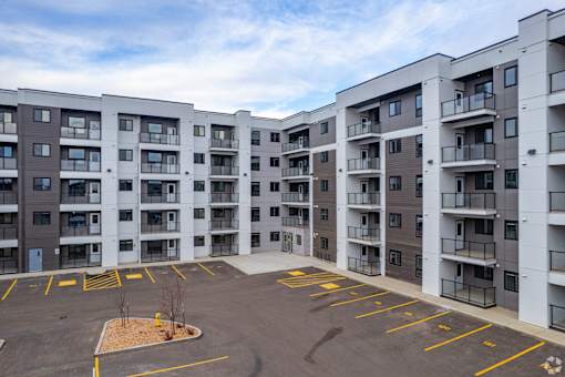 A parking lot in front of apartment buildings.at The Pointe at Riverview, Edmonton, AB T6M 3H4
