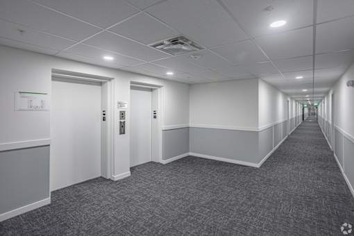 Long Hallway And Elevator Access at The Pointe at Riverview, Alberta, T6M 3H4