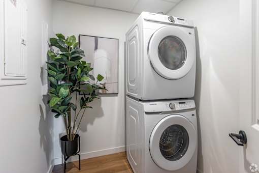 A stack of washing machines in a laundry room.at The Pointe at Riverview, Edmonton, T6M 3H4