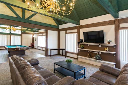 A large room with a pool table and a television.