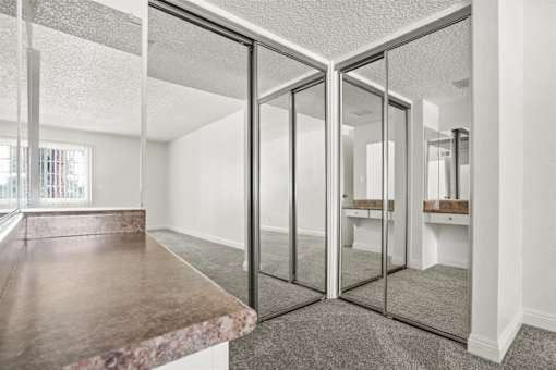 A room with a marble countertop and a glass door.