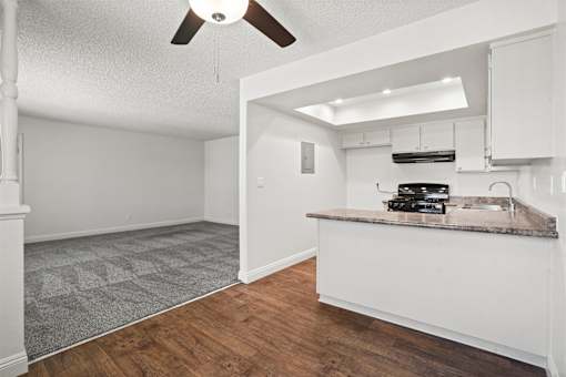 A kitchen area with a counter and a fan.