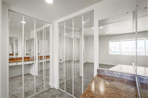 A room with a marble table and glass walls.