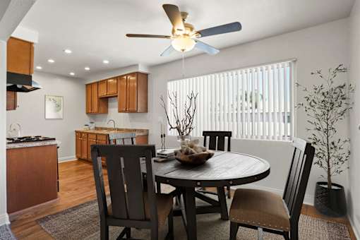 A dining room with a table and chairs.