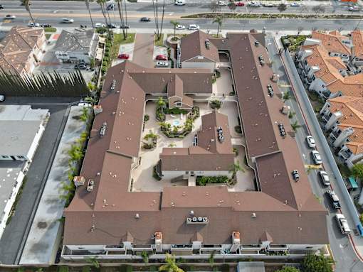 A large brown building with a courtyard in the middle.