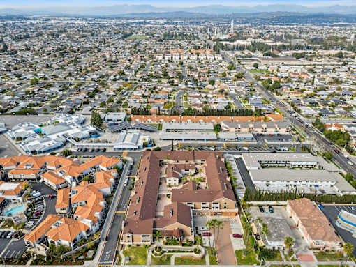 A bird's eye view of a city with a large building in the center.