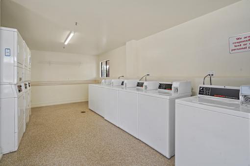 A laundry room with washers and dryers.