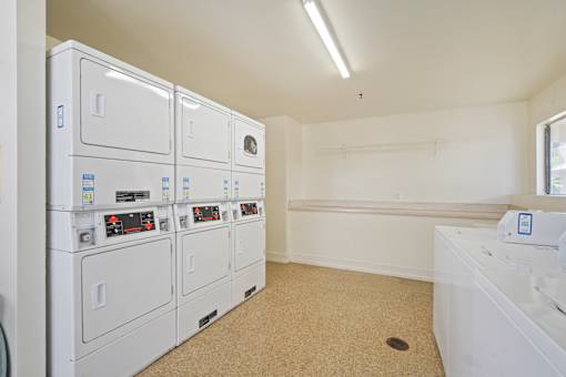 A row of white electrical boxes are lined up in a room.
