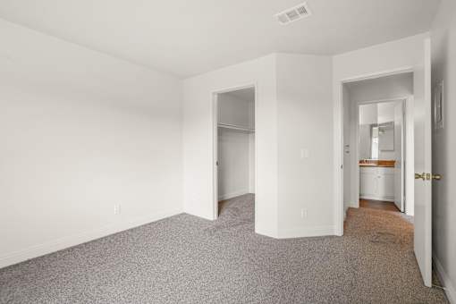A room with carpeted floor and white walls.