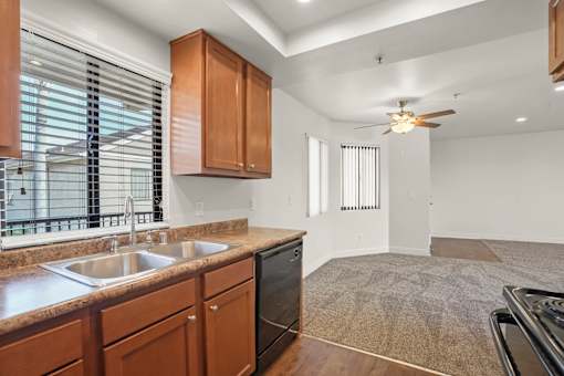 A kitchen with wooden cabinets and a stainless steel sink.