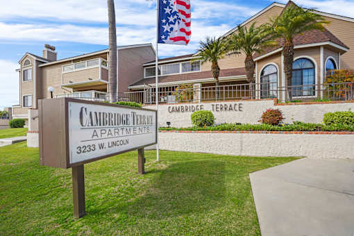 A sign for Cambridge Terrace Apartments stands in front of a building.