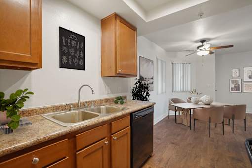 A kitchen with a sink and a fridge.