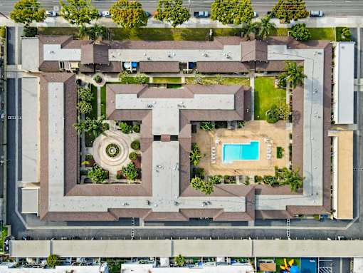 A large complex with a pool and a circular garden in the middle.