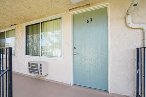 A blue door with the number 63 on it.