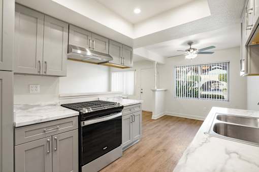 A modern kitchen with a stainless steel oven and a marble countertop.