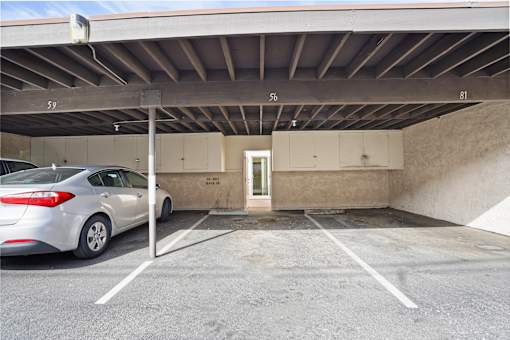 A car is parked in a parking garage with a door marked "EXIT".
