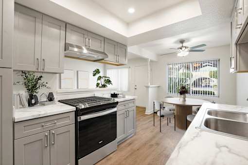 A modern kitchen with a stainless steel oven and a marble countertop.