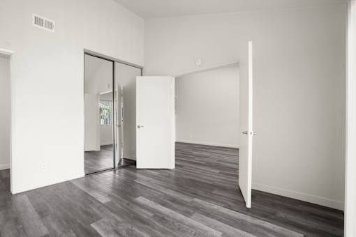 A room with a white door and a white wall.