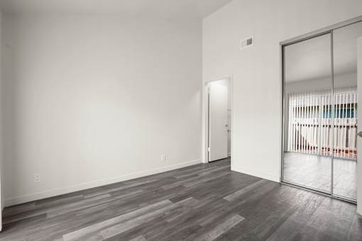 A room with a grey floor and a white wall.