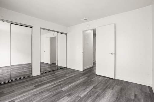 A room with a wooden floor and white walls.
