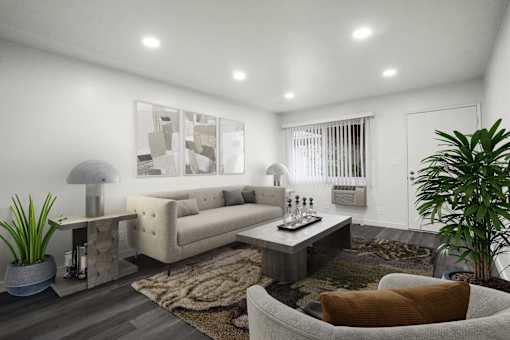 A modern living room with a white sofa, a grey armchair, a coffee table, and a rug.