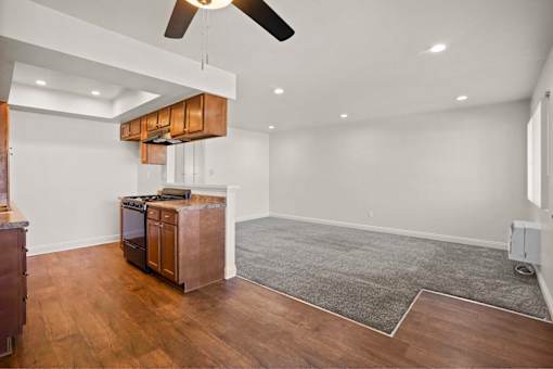 A room with a wooden floor and a ceiling fan.