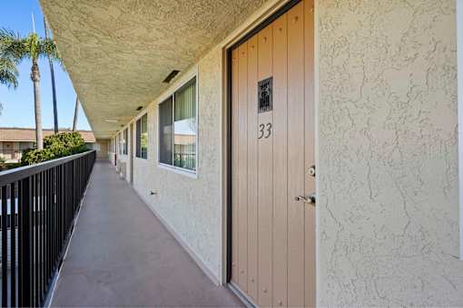 A balcony with a door numbered 33.