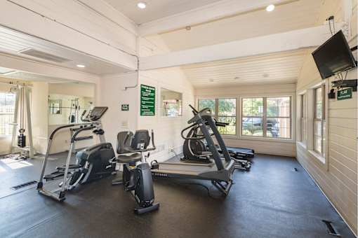 A gym with treadmills and exercise bikes.