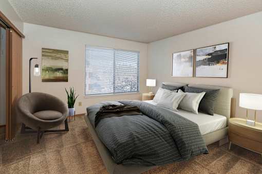 A bedroom with a large bed and a chair.