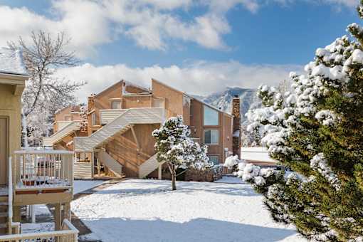 A house with a snow-covered front yard.