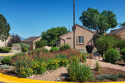 A house numbered 2400 is surrounded by a well-kept garden.