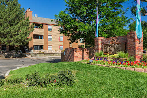 A brick sign that says Winridge in front of a building.