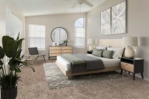 A bedroom with a large bed, a potted plant, and a mirror on the wall.