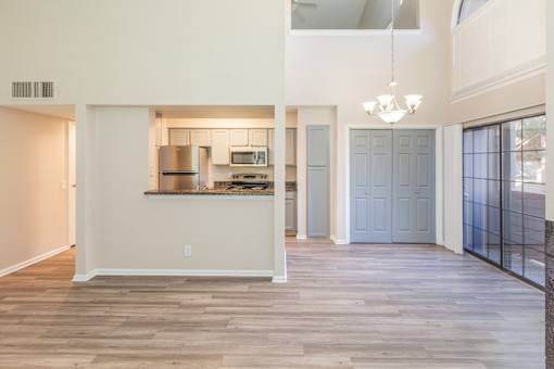 A kitchen with a refrigerator, microwave, and oven.