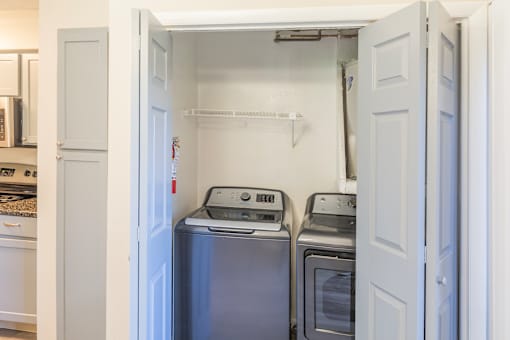 A small laundry room with a washer and dryer.
