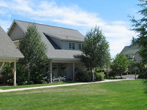 A house with a grey roof and a white porch.