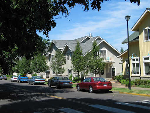 A red car is parked on the side of a street.